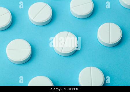 Pills background. Pills, drags and medecine concept. White tablets on a blue background Stock Photo