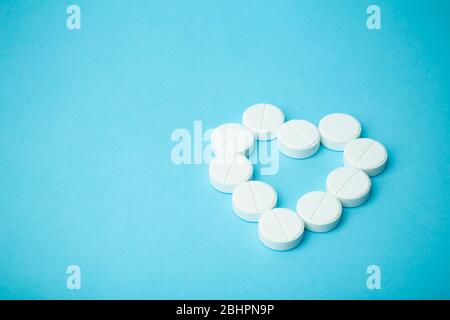 Pills background. Pills, drags and medecine concept. White tablets on a blue background Stock Photo