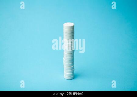 Pills background. Pills, drags and medecine concept. White tablets on a blue background Stock Photo