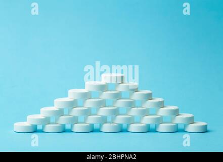 Pills background. Pills, drags and medecine concept. White tablets on a blue background Stock Photo