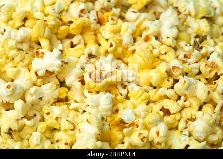 Popcorn on a colored background. Minimal food concept. Entertainment, film and video content. Aesthetics 80s and 90s concept Stock Photo