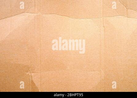 Full frame texture of blank crumpled and wrinkled brown cardboard background. Stock Photo