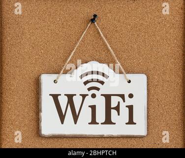 The inscription on the plate in vintage style. Cork-board background. Close up. Stock Photo