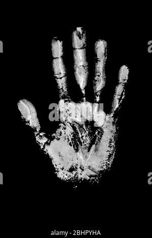 White watercolor print of human hand on black background isolated close up, handprint illustration, monochrome palm and fingers silhouette mark, track Stock Photo
