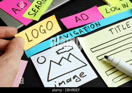 Web designer creating and planning site with sketch and design parts. Stock Photo