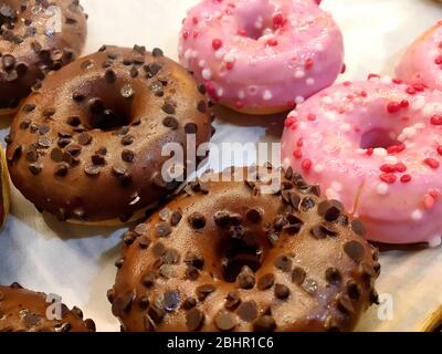 Photo of Chocolate and strawberry donut with sugary and sprinkles Stock Photo