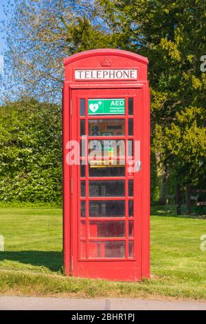 Life saving defibrillator located in an old telephone box in Perry Green, Much Hadham, Hertfordshire. UK Stock Photo
