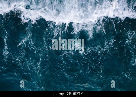 Overhead view to blue stormy ocean waves with white foam. Stock Photo