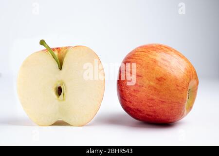Isolated apples. Whole red apple and a half isolated on white background with clipping path Stock Photo