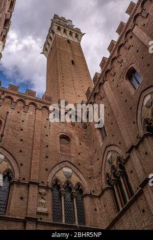 Siena Tower - Looking up towards Torre del Mangia (Mangia tower) from inside of Palazzo Publico inner courtyard in Siena, Tuscany, Italy.