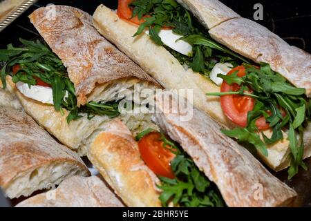 Sandwiches display during fast food festival outdoor event. Outside catering. Food Buffet Catering Dining Eating Party Sharing Concept. Meat, bacon, c Stock Photo