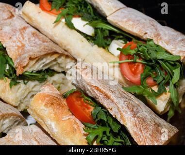 Sandwiches display during fast food festival outdoor event. Outside catering. Food Buffet Catering Dining Eating Party Sharing Concept. Meat, bacon, c Stock Photo