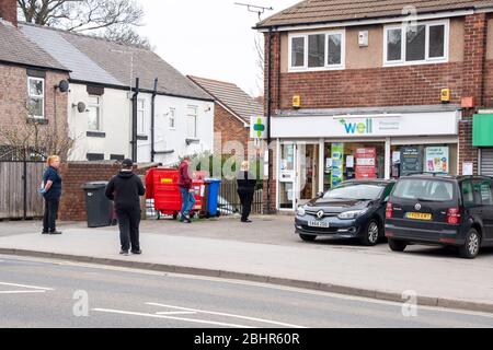 Sheffield UK –  March 30 2020: Social distancing queue at Well Pharmacy during coronavirus covid-19 pandemic April 2020 at Richmond Road Stock Photo