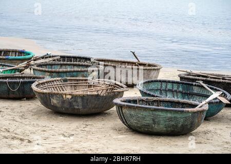 Close up, traditional Vietnamese boat placed on a tropical beach located in My Khe Beach, Danang, Vietnam. This round basket boat is made of woven bam Stock Photo