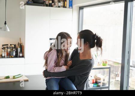 Home life, a school morning during lockdown. A girl and her mother in a kitchen. Stock Photo