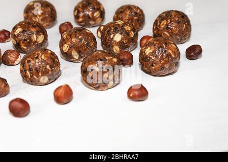 Energy balls with oat, chocolate and nuts on gray wood background. Healthy vegan and raw food diet. Proper nutrition concept. Selective focus. Copy space. Stock Photo