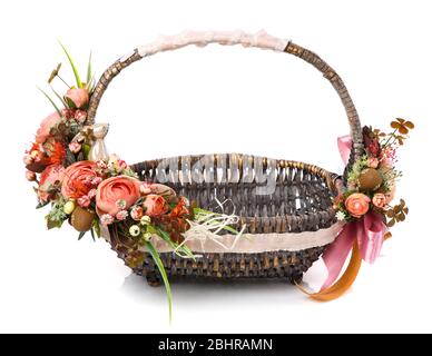 Beautiful flower arrangement on original brown wicker basket. Floral concept. Easter Basket. Spring colors. Stock Photo