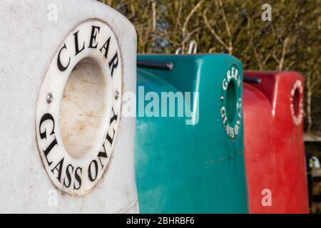 Multicolored waste glass recycling center bins for bottles and jars of different colors Stock Photo