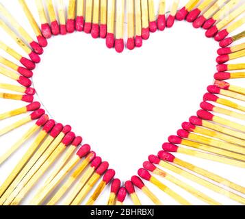 Heart made with red colored match sticks in front of a white isolated background Stock Photo