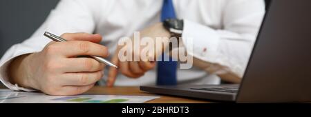 Office worker working on laptop and taking notes Stock Photo