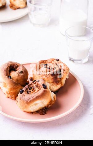Cinnamon buns  served in plate on breakfast morning table, close up Stock Photo