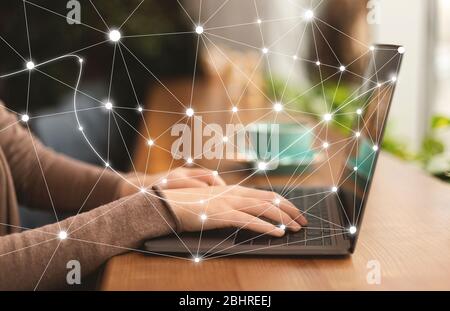 Woman using personal computer with flying network Stock Photo