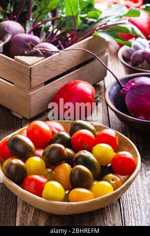 Fresh organic  homegrown vegetables on rustic wooden table, sustainable living, healthy eating, plant based food, cooking ingredients, beets, tomatoes Stock Photo