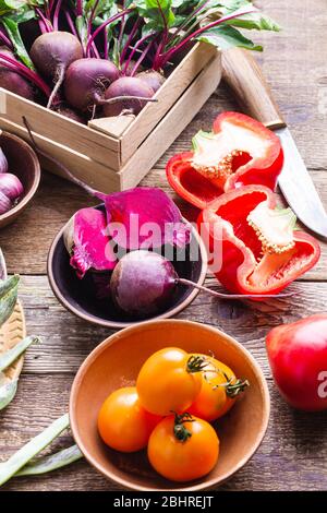 Fresh organic  homegrown vegetables on rustic wooden table, sustainable living, healthy eating, plant based food, cooking ingredients, beets, tomatoes Stock Photo