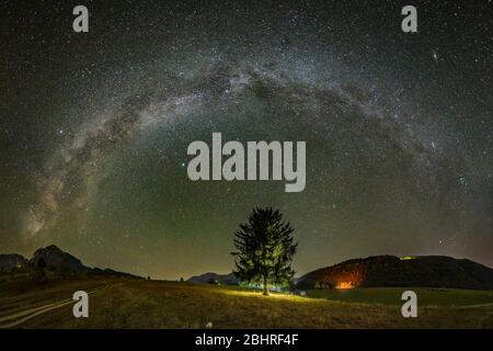 Milky way over the Piatra Craiului mountains in Romania Stock Photo