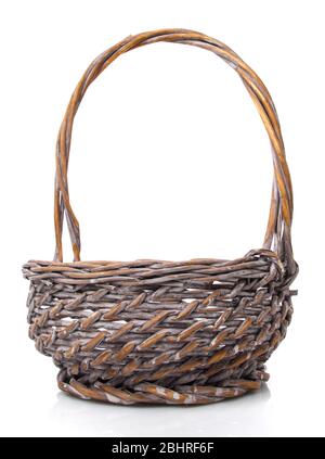 Round small wicker basket on a white background. The basket is made of vines. Stock Photo