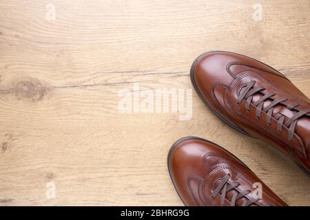 Brown men leather shoes on wooden background Stock Photo