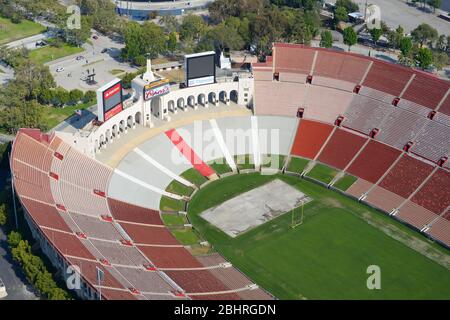 Close aerial view of Los Angeles Memorial Coliseum, a huge Olympic Stadium with a football field in California, United States. Empty sports stands. Stock Photo