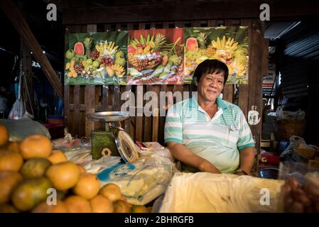 A fresh fruit seller at the Samut Sakhon street market, Bangkok, Thailand. Stock Photo