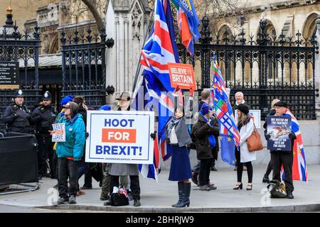 Pro Brexit campaigner Lydia Grant, middle, with Believe in Britain placard at Parliament in Westminster, London, UK Stock Photo