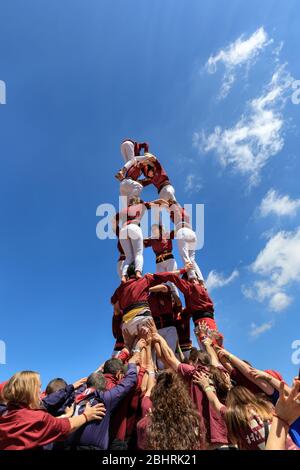 Castellers, people building a traditional Spanish castell or human tower at a festival in Catalonia, Spain Stock Photo