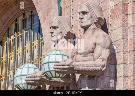 Granite figures holding lamps at the Central railway station. Helsinki, Finland, Europe Stock Photo