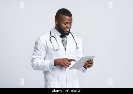 Modern african medical doctor using digital tablet Stock Photo