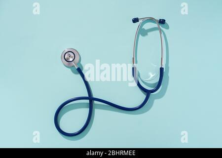 Phonendoscope on empty blue background, place for inscription. Concept of medivine. Stock Photo