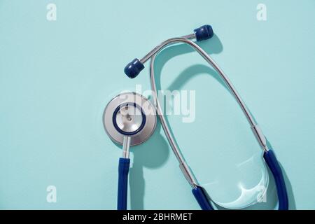 Phonendoscope on empty blue background, place for inscription. Concept of medivine. Stock Photo