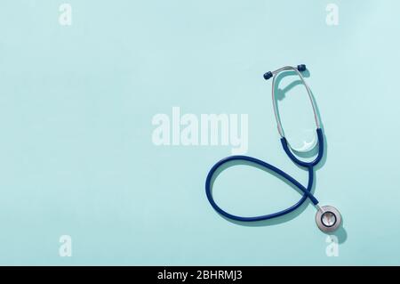 Phonendoscope on empty blue background, place for inscription. Concept of medivine. Stock Photo