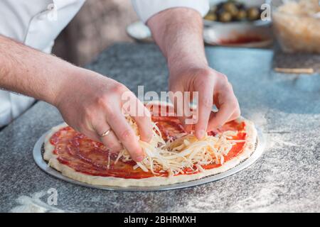 Cooking pizza in the oven by a restaurant chef Stock Photo