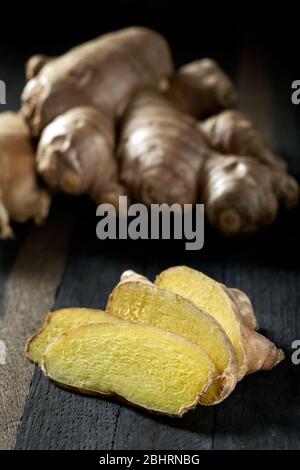Sliced ginger root on a wooden table. Stock Photo