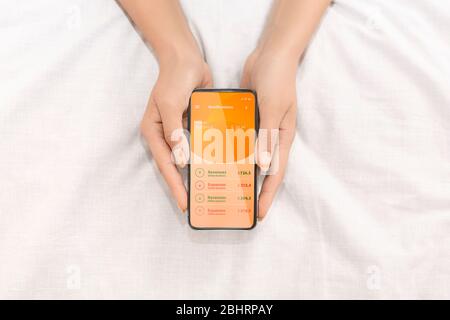 Close up of woman showing screen with account balance Stock Photo