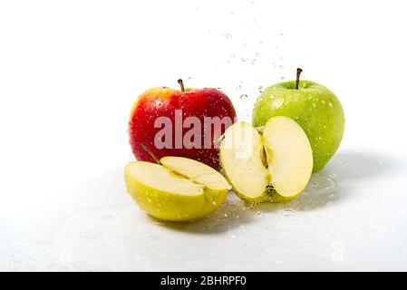 three apples with water splash. Three apples red, green, and yellow with warer splashes on white background Stock Photo