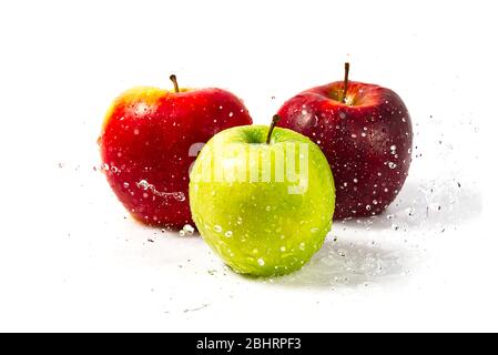 three apples with water splash. Three apples red, green, and yellow with warer splashes on white background Stock Photo