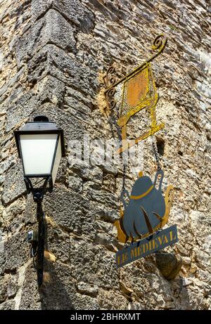 France, La Couvertoirade, fortified town owned by the Knights Templar 12-13C, replaced by Hospitallers 14C, Le Medieval, restaurant sign Stock Photo