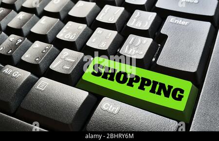 Black keyboard with one green key labeled by shopping sign. Stock Photo