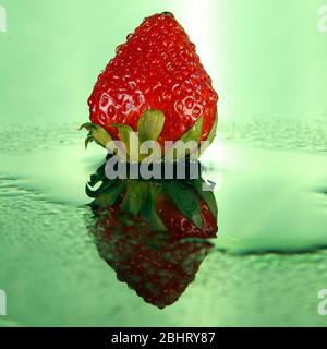 Sweet strawberries, shot on studio with two strobe lights with a green background Stock Photo