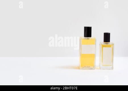Two bottles of essence perfume on gray background Stock Photo