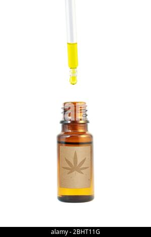 Cannabidiol oil in the dark amber glass bottle and dropper isolated on white. Сannabis leaf silhouette on the paper label. Stock Photo